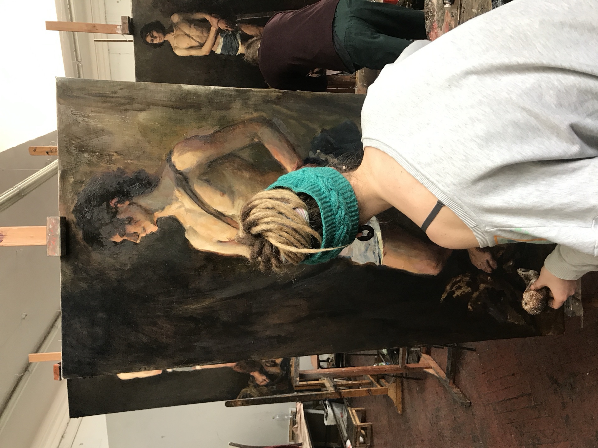 Lev Boyko at work - paint on the brush, the model holding the pose.
